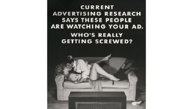 Old advert showing people making out on a sofa, illuminated by the light of their TV.